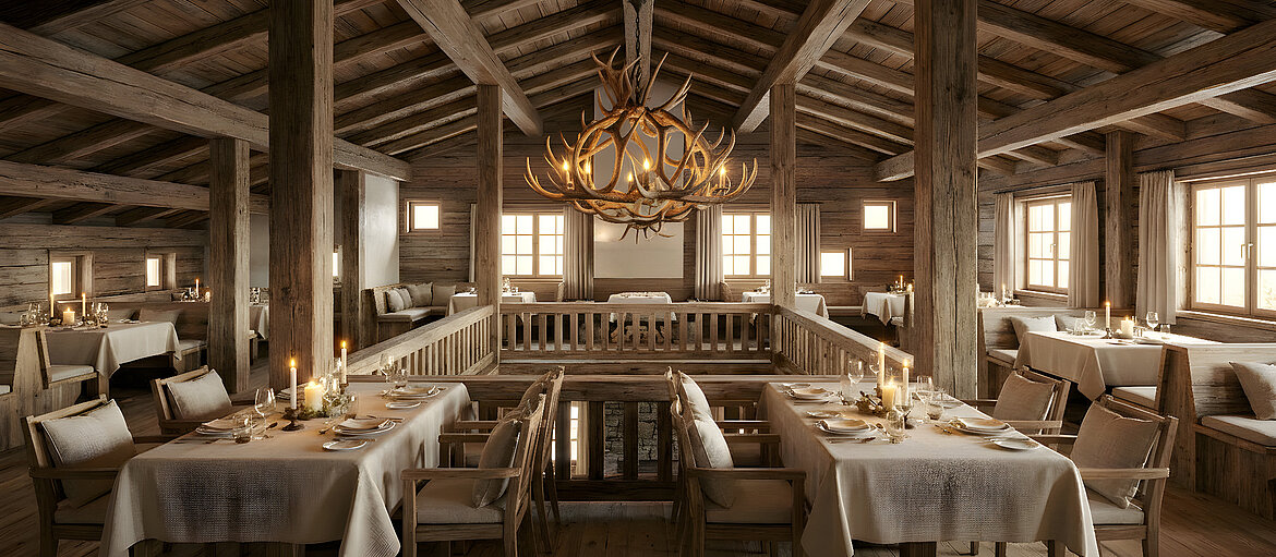 Warmer, komplett in Altholz verkleideter Restaurantbereich mit liebevoll gedeckten Tischen, flackerndem Kerzenschein und Lammfell-strahlenden Stühlen, dazu große Fenster mit Blick auf die Montafoner Bergwelt – der perfekte Rahmen für Gourmetdinner, Hochzeiten und exklusive Feiern im Chaletdorf Vermala Gut in Vorarlberg.